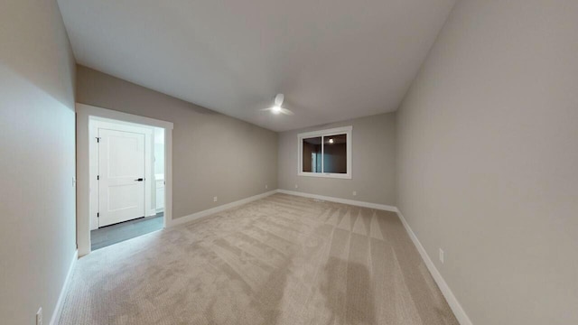 unfurnished room with light colored carpet and baseboards