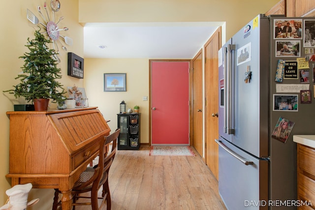 kitchen featuring light wood-style flooring, high quality fridge, and beverage cooler