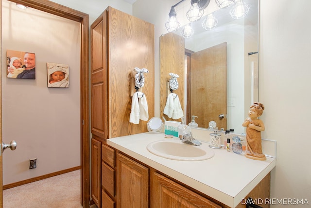 bathroom featuring baseboards and vanity