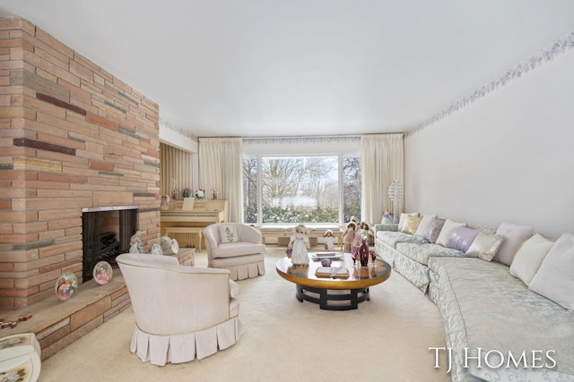 carpeted living room with a brick fireplace