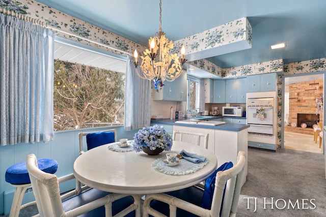 dining space with a chandelier and dark carpet