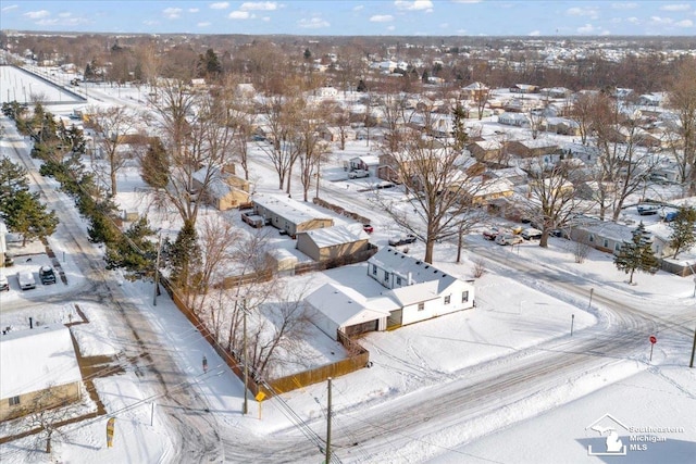 snowy aerial view featuring a residential view