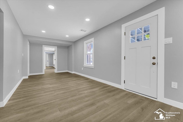 entryway with light wood-type flooring, visible vents, and baseboards