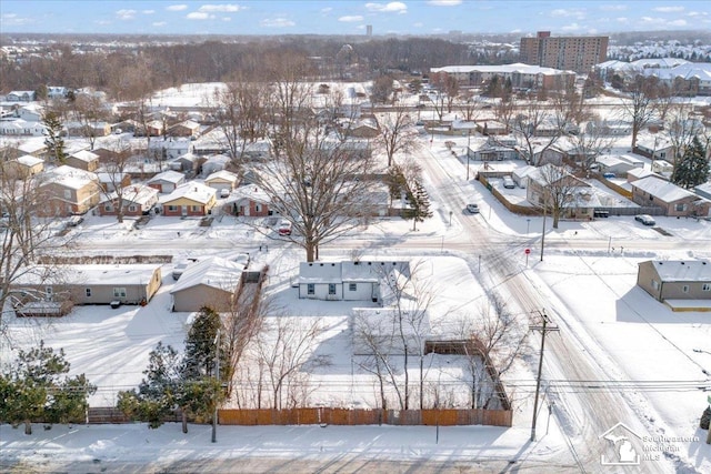 snowy aerial view featuring a residential view