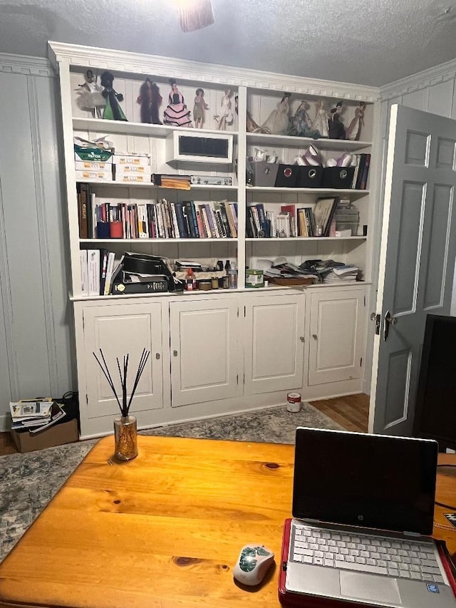 interior space with a textured ceiling and wood finished floors