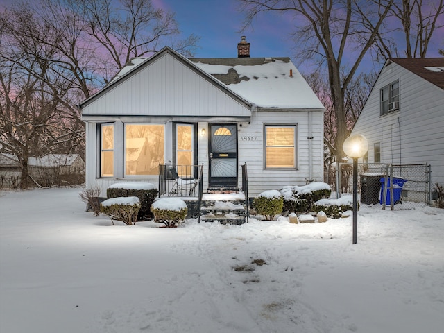 view of front of home with fence and a chimney