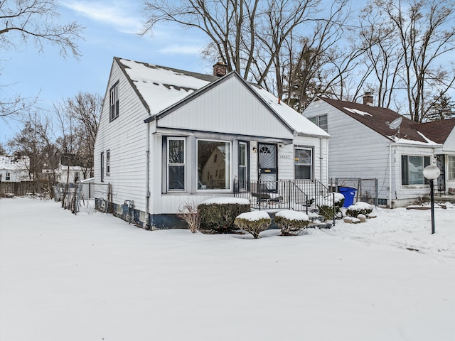 bungalow-style home featuring board and batten siding and a chimney