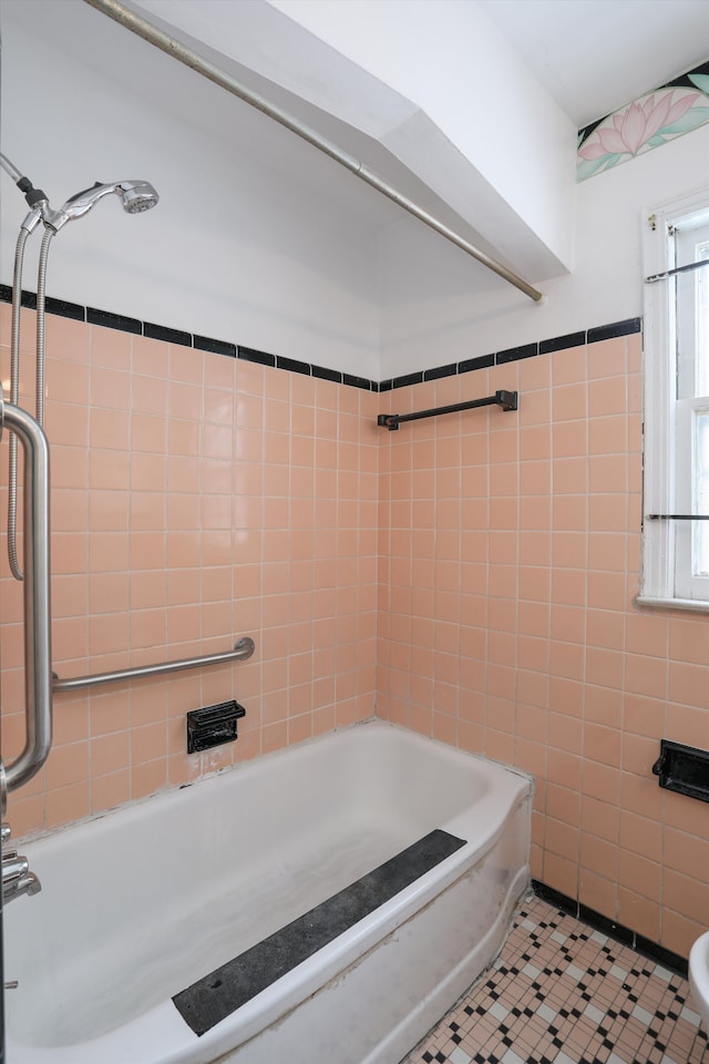 full bathroom featuring tile patterned flooring, tub / shower combination, and tile walls