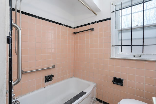 full bathroom with toilet and tile walls