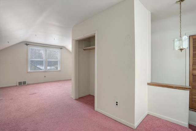 additional living space featuring light carpet, baseboards, visible vents, and vaulted ceiling