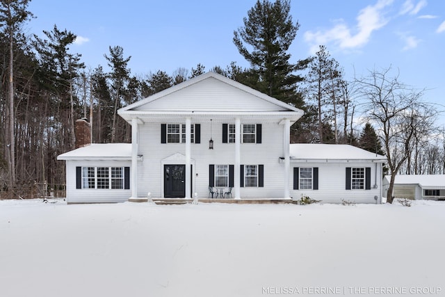 greek revival inspired property with a chimney