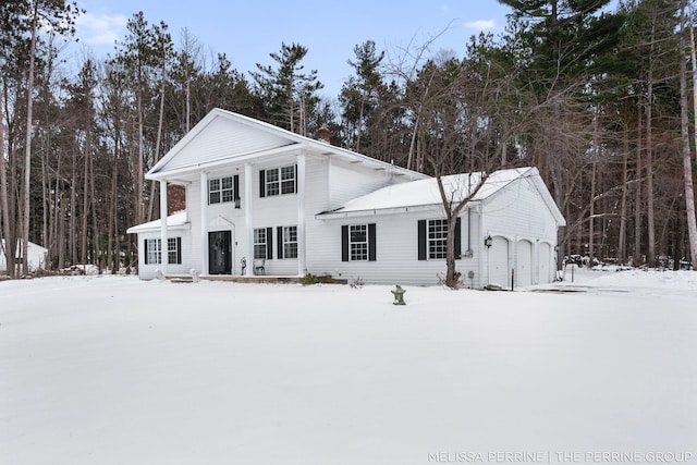 greek revival inspired property with a garage