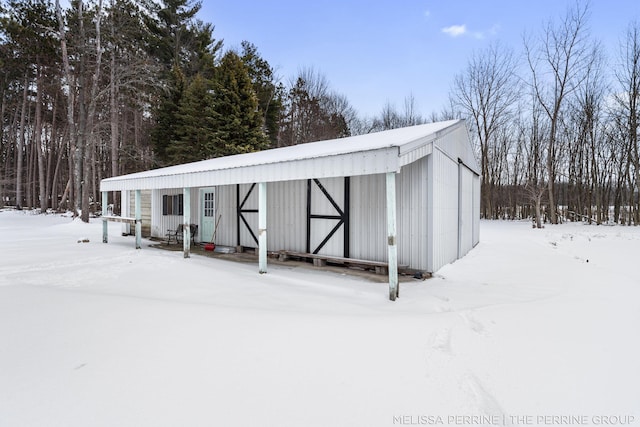 snow covered structure with an outdoor structure