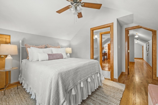 bedroom featuring vaulted ceiling, ceiling fan, light wood-type flooring, and baseboards