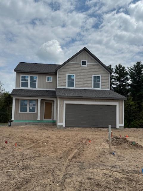 1967 Lowe Dr, Spring Lake, MI 49456 - view of front of property featuring a garage and a shingled roof