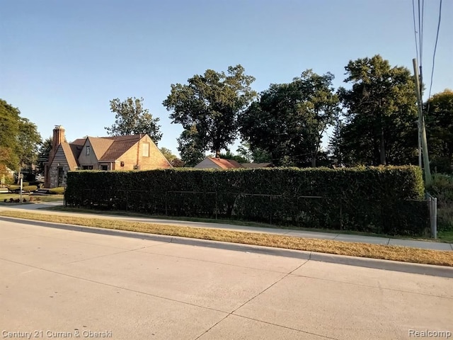 view of road with sidewalks and curbs