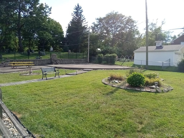 view of home's community with a lawn and fence