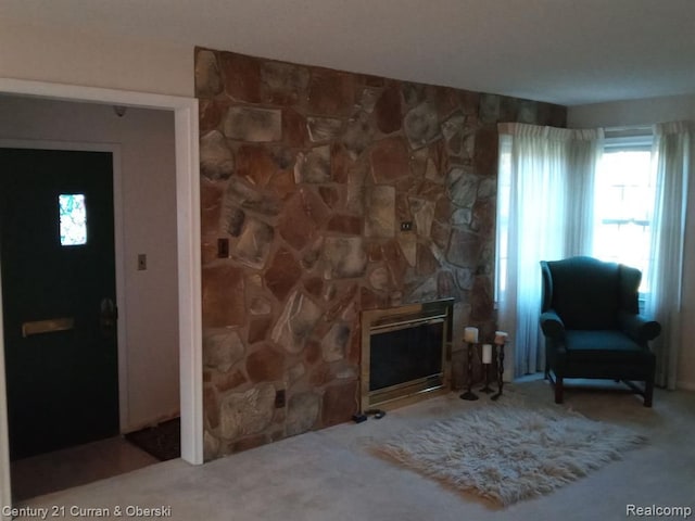 sitting room featuring a fireplace and carpet flooring