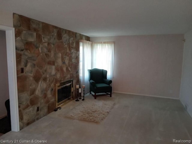 living area featuring carpet floors and a fireplace