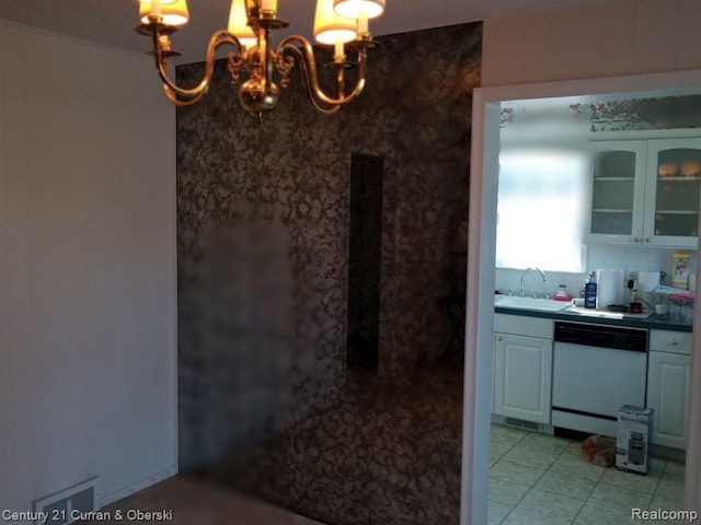 interior space with tile patterned flooring, a notable chandelier, a sink, backsplash, and crown molding