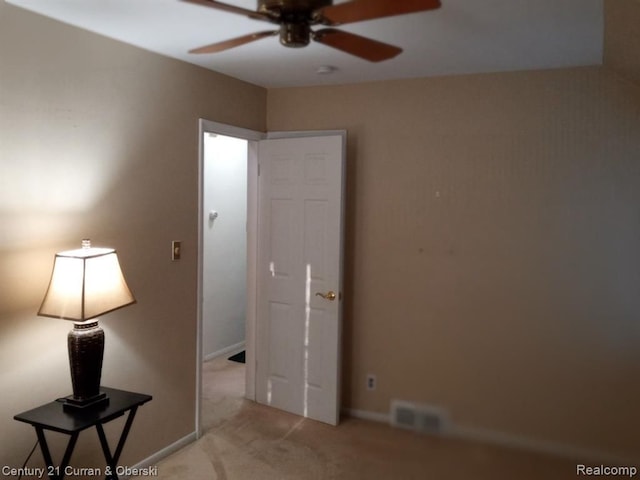 unfurnished bedroom featuring baseboards, visible vents, and light colored carpet