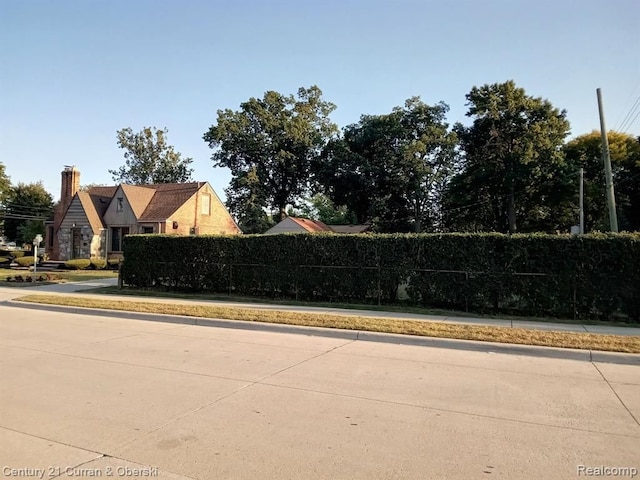 view of home's community featuring fence