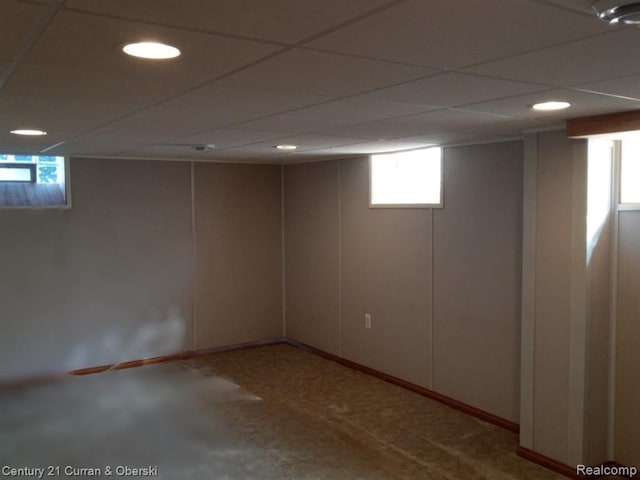 basement featuring a paneled ceiling and recessed lighting