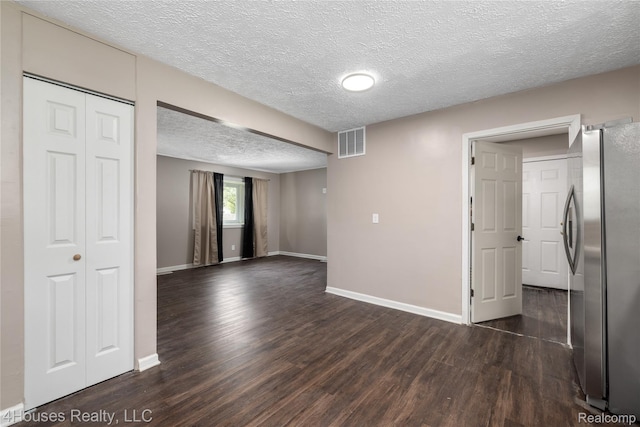 6291 Edmund St, Romulus, MI 48174 - empty room with dark wood-style flooring and a textured ceiling