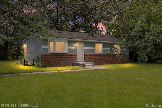 6291 Edmund St, Romulus, MI 48174 - view of front facade featuring a front lawn and brick siding