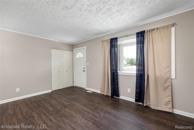6291 Edmund St, Romulus, MI 48174 - foyer with dark wood-style floors, a textured ceiling, and crown molding