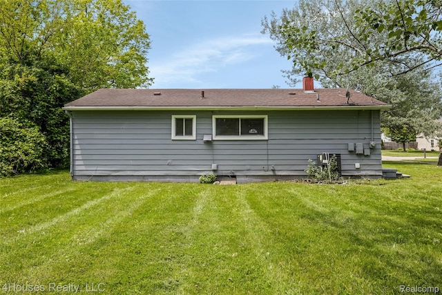 6291 Edmund St, Romulus, MI 48174 - back of property featuring a yard and a chimney