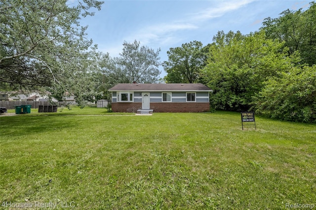 6291 Edmund St, Romulus, MI 48174 - rear view of property with brick siding and a yard