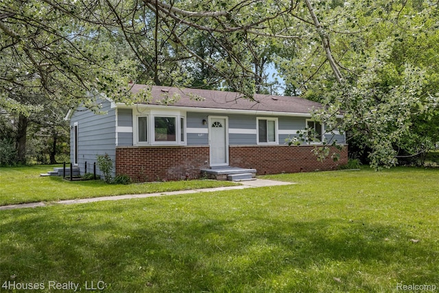 6291 Edmund St, Romulus, MI 48174 - view of front of home with brick siding and a front lawn