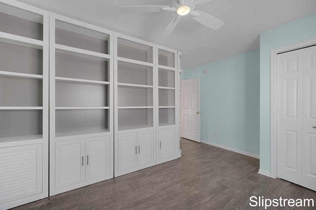 unfurnished bedroom with a ceiling fan, a closet, baseboards, and wood finished floors