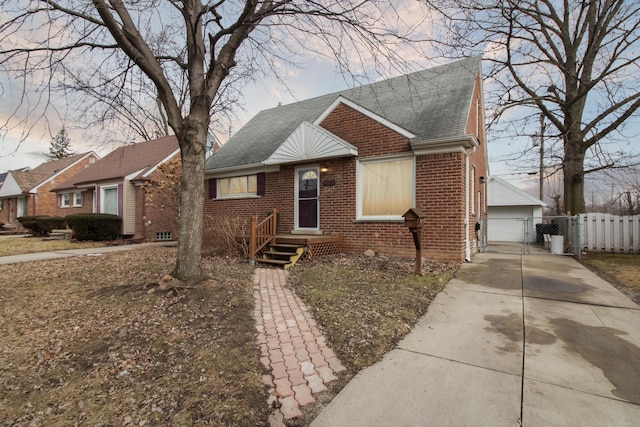 bungalow-style house with a garage, brick siding, fence, roof with shingles, and a gate