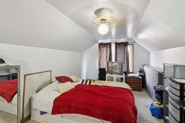 carpeted bedroom featuring lofted ceiling