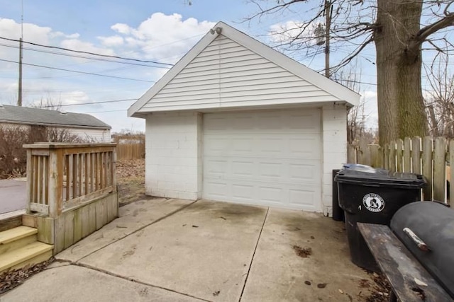 detached garage with driveway and fence