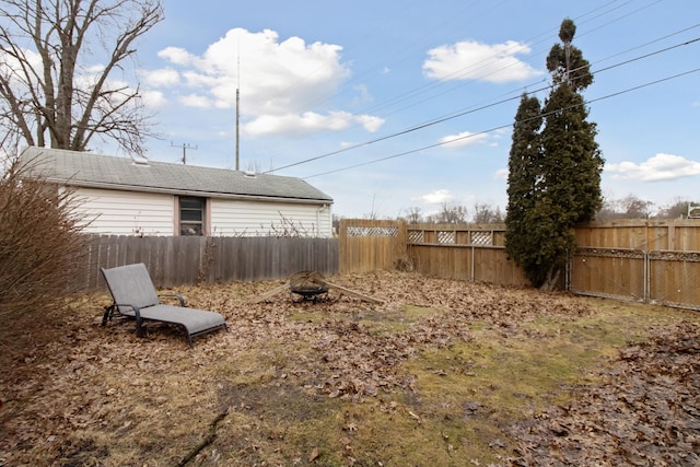 view of yard featuring an outdoor fire pit and a fenced backyard