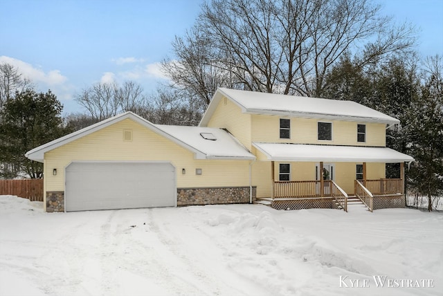 view of front of property with an attached garage, covered porch, and stone siding