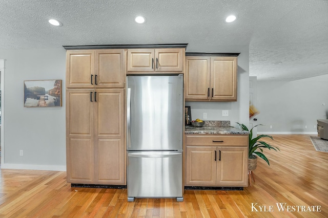 kitchen with light wood-style floors, freestanding refrigerator, baseboards, and recessed lighting