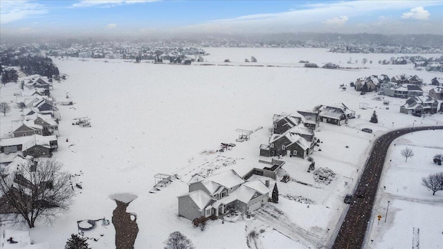 snowy aerial view with a residential view