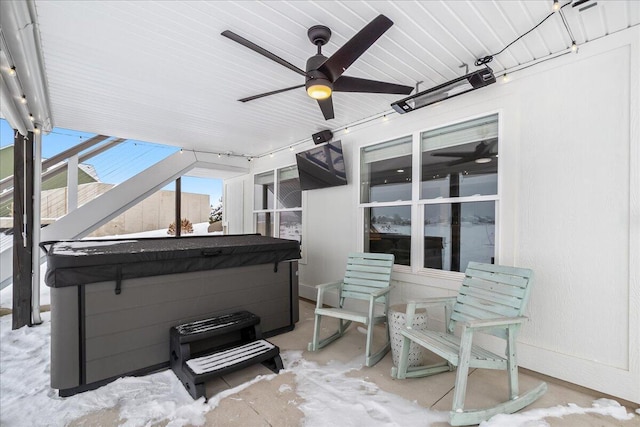 view of patio featuring a ceiling fan and a hot tub