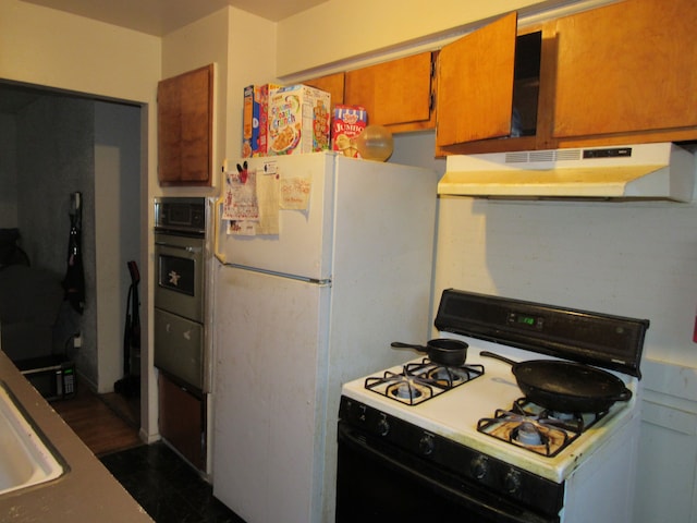 kitchen featuring light countertops, white appliances, brown cabinets, and under cabinet range hood