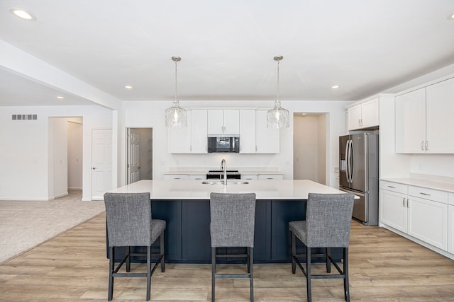72180 Van Dyke, Bruce, MI 48065 - kitchen featuring black microwave, stainless steel refrigerator with ice dispenser, light countertops, white cabinetry, and recessed lighting
