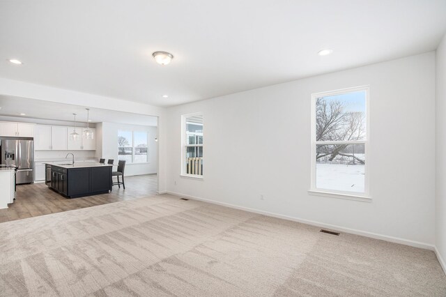 72180 Van Dyke, Bruce, MI 48065 - living room featuring healthy amount of natural light, baseboards, recessed lighting, and light carpet