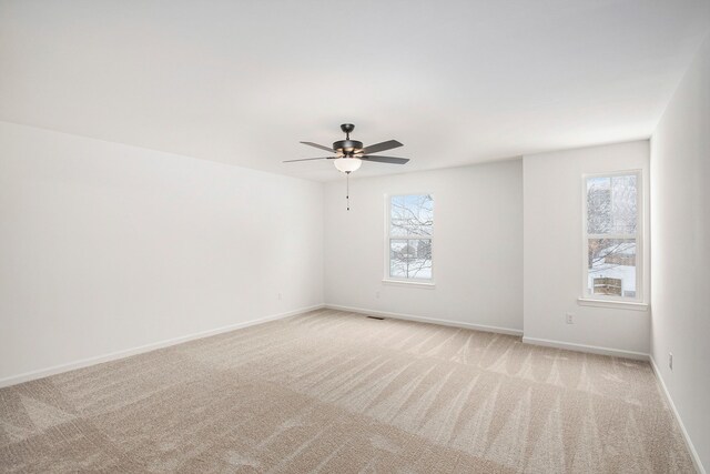 72180 Van Dyke, Bruce, MI 48065 - empty room featuring light carpet, ceiling fan, and baseboards