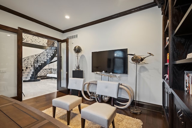 interior space with stairway, crown molding, visible vents, and wood finished floors