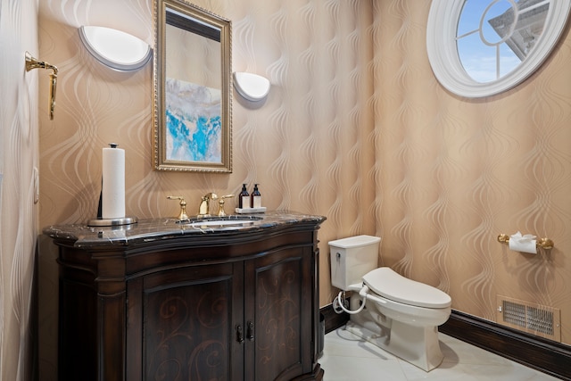 bathroom featuring visible vents, toilet, vanity, tile patterned flooring, and wallpapered walls