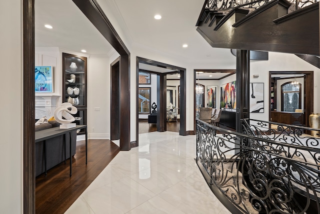 corridor featuring baseboards, recessed lighting, and crown molding