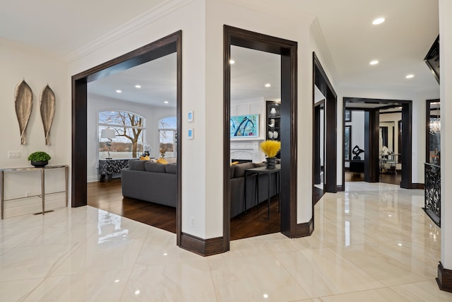 hallway featuring ornamental molding, recessed lighting, marble finish floor, and baseboards